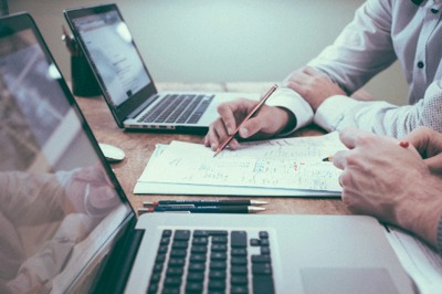 Two Men Working On Documents
